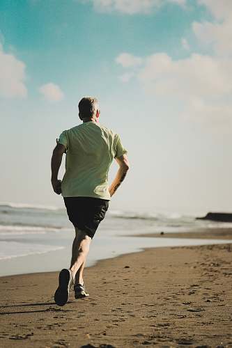 working out man running on seashore human